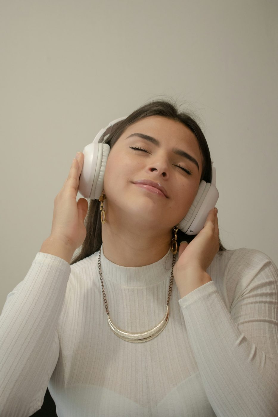 Person listening to audio through headphones, representing NLOM's Spotify, Podcasts & Radio channel
