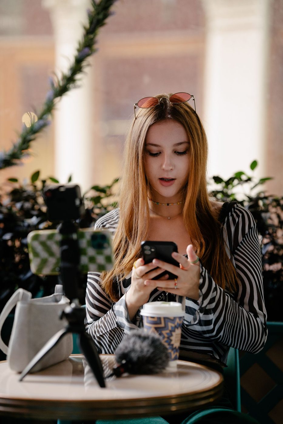 Young creator filming content on a phone, representing NLOM's TikTok, Pinterest & Snapchat channel